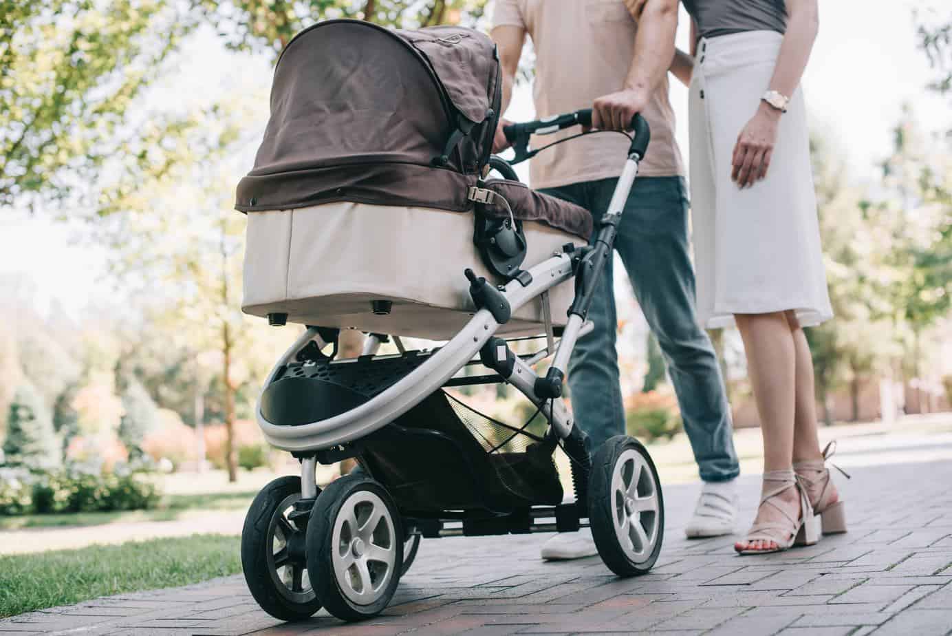 cropped mother and father pushing bugaboo fox stroller