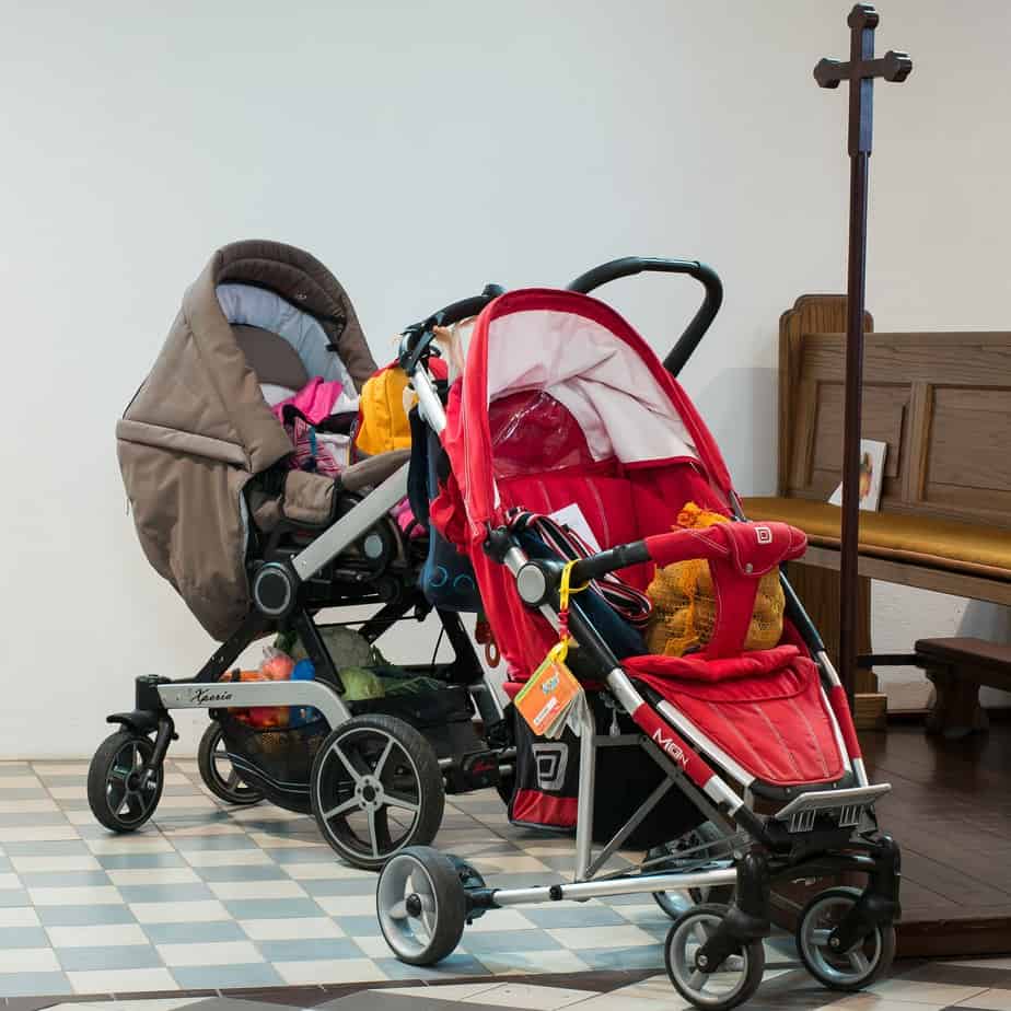red and brown strollers standing in the church 