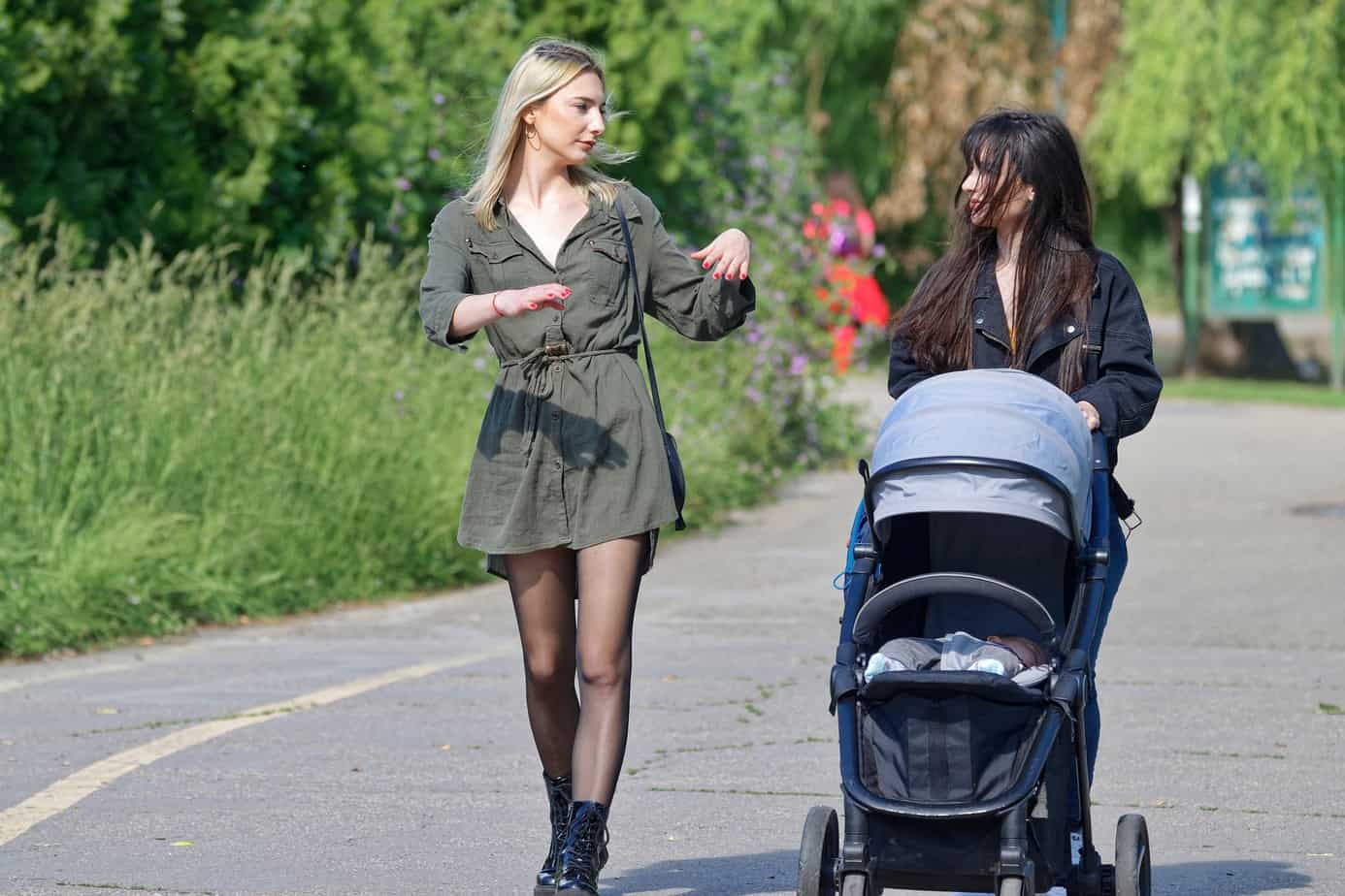 two women walking with the stroller 