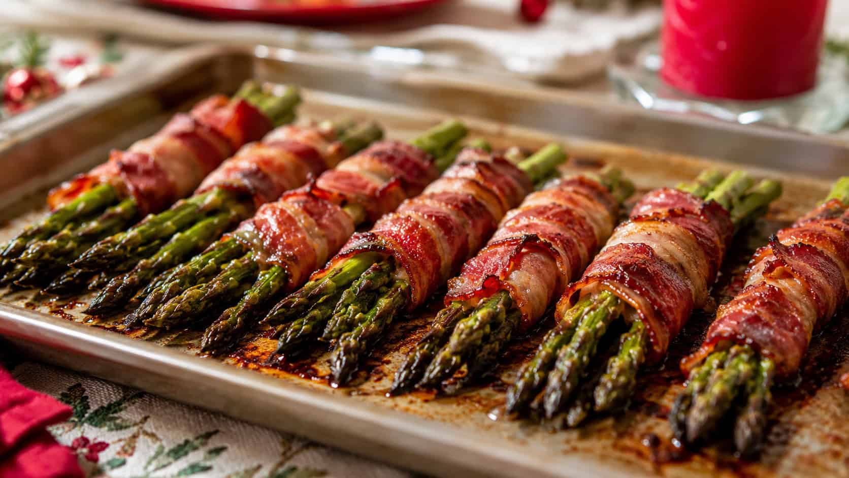 crispy bacon-wrapped asparagus bundles in a wide horizontal shot, lined up on a sheet pan with caramelized edges on a holiday table, natural light, shallow depth of field, landscape orientation