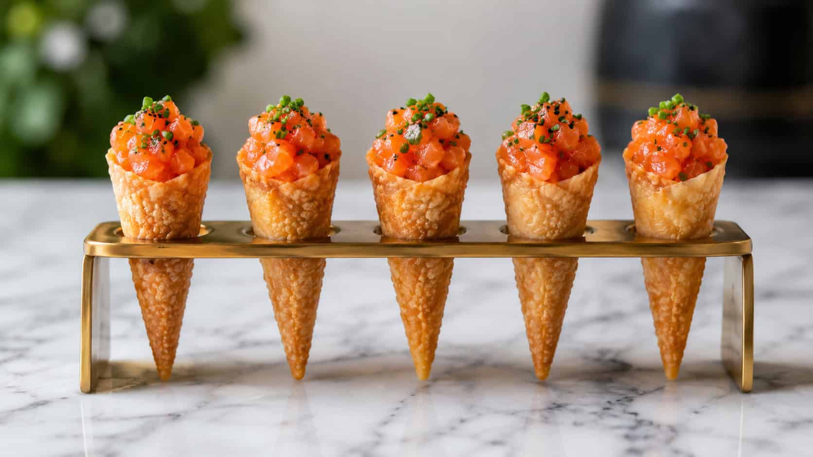 crisp savory cones filled with bright orange salmon tartare and chives in a wide horizontal shot, standing in a cone holder on a marble surface, clean modern light, shallow depth of field, landscape orientation