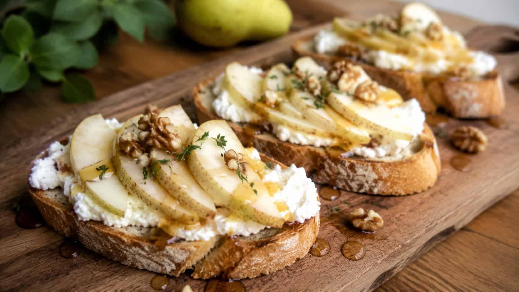 bruschetta topped with creamy goat cheese, fanned pear slices, walnuts, and honey drizzle on a wooden serving board, in a wide horizontal shot, natural light, shallow depth of field, landscape orientation