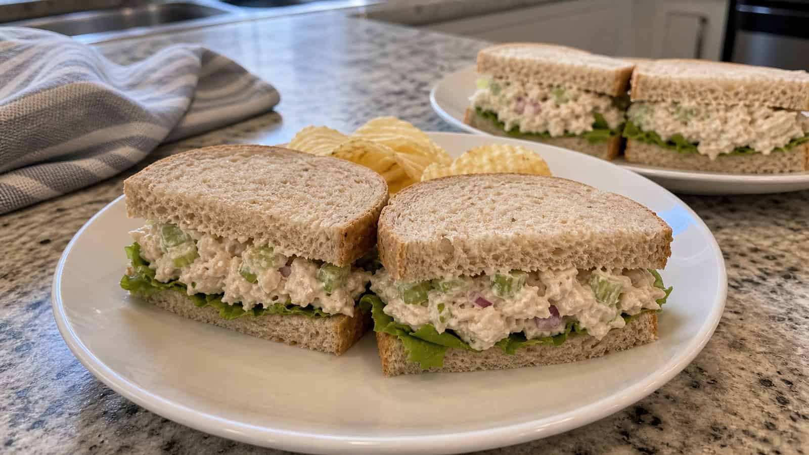 quick canned chicken salad sandwiches on plates in a home kitchen with no visible cans or labels