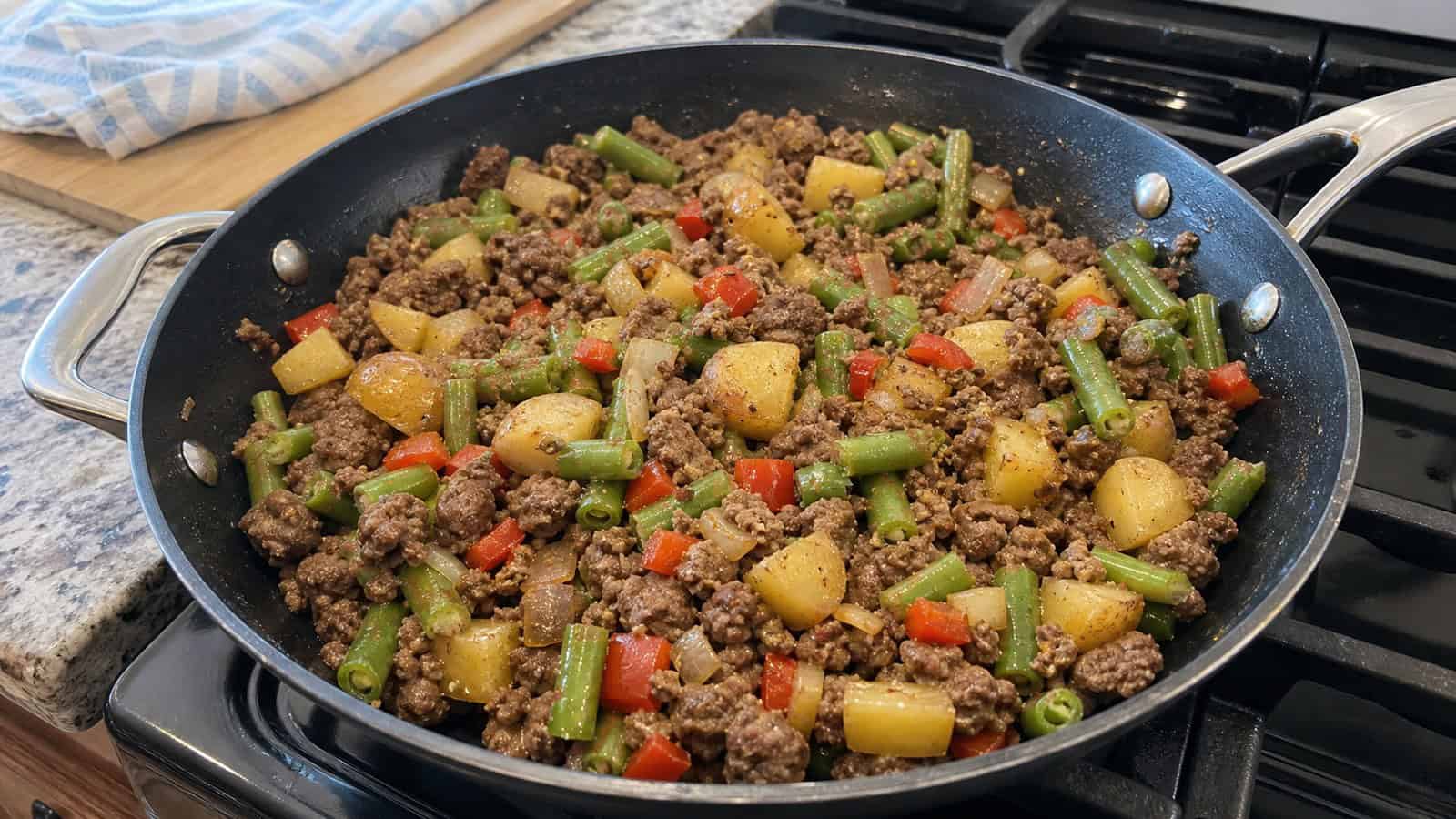 easy ground beef skillet dinner on a stove in a normal home kitchen