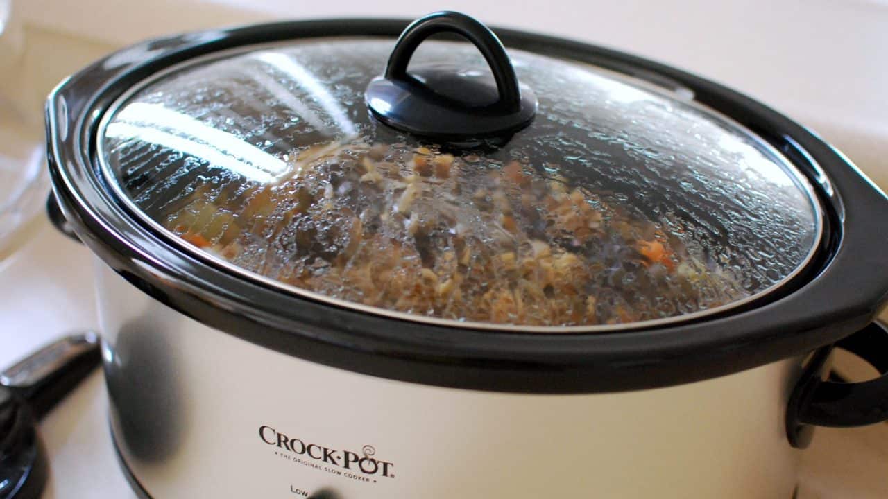 Crock-Pot slow cooker with a dinner cooking under the glass lid