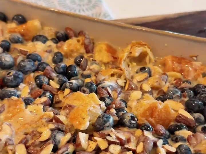 Blueberry Croissant Bake 5 The fully baked golden croissant bake studded with blueberries and almonds sits ready in its dish.