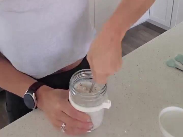Creamy High-Protein Overnight Oats With Fairlife Milk 5 The jar now holds a fully mixed, creamy overnight oats blend with a spoon still inside it.
