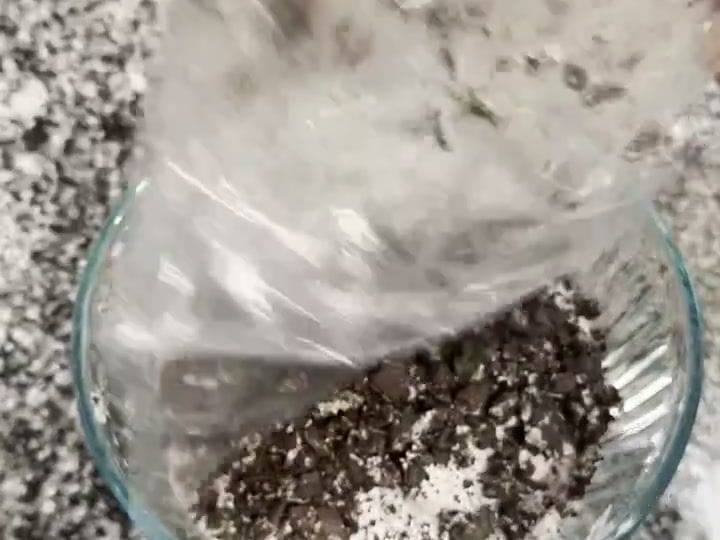 A glass bowl filled with Oreo fluff is topped with a generous layer of crushed Oreo crumbs.