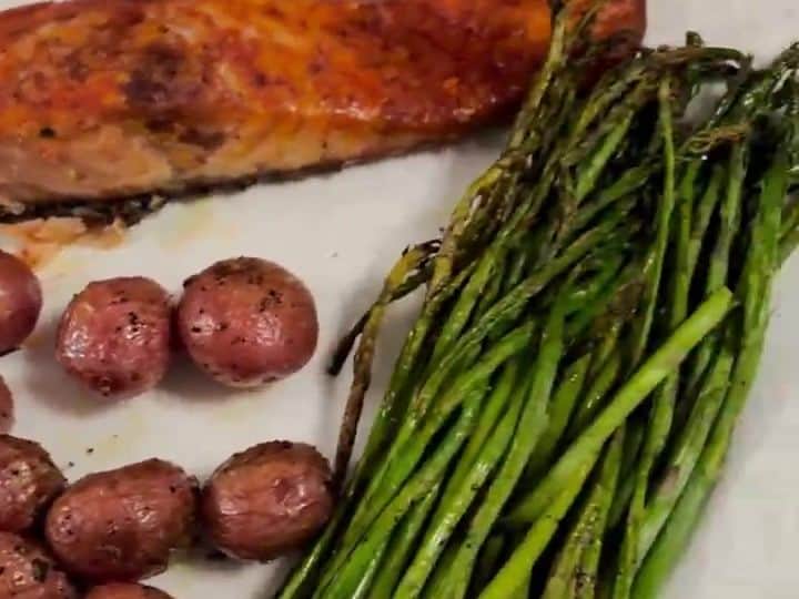 Roasted Salmon with Lemon-Pepper Asparagus and Potatoes 6 A close-up of a plate with roasted salmon, small red potatoes, and asparagus spears ready to eat.
