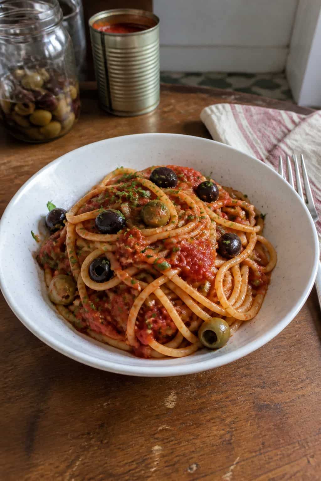 17 Pasta Dinners That Feel Fancy But Use Pantry Staples 5 A bowl of tomato pasta studded with sliced black olives and small capers