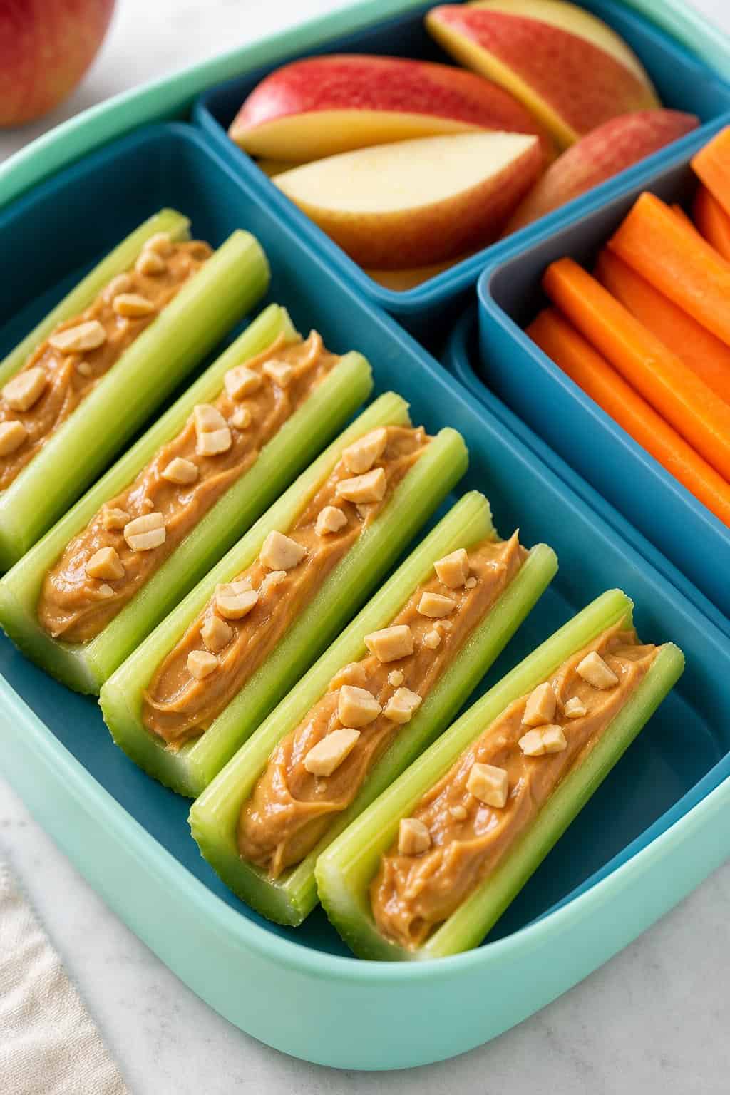 16 Easy Lunchbox Sides Kids Will Eat 16 Celery sticks filled with peanut butter arranged in a colorful lunchbox.