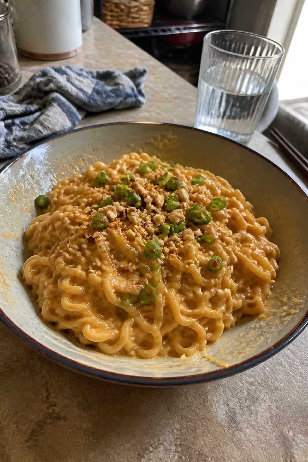 17 Budget Dinners That Use What You Already Bought 9 A bowl of peanut butter ramen noodles on a kitchen table.