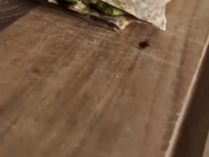 Pesto Shrimp Quesadillas with 36 Grams of Protein 4 A quesadilla sliced into wedges resting on a wooden cutting board.