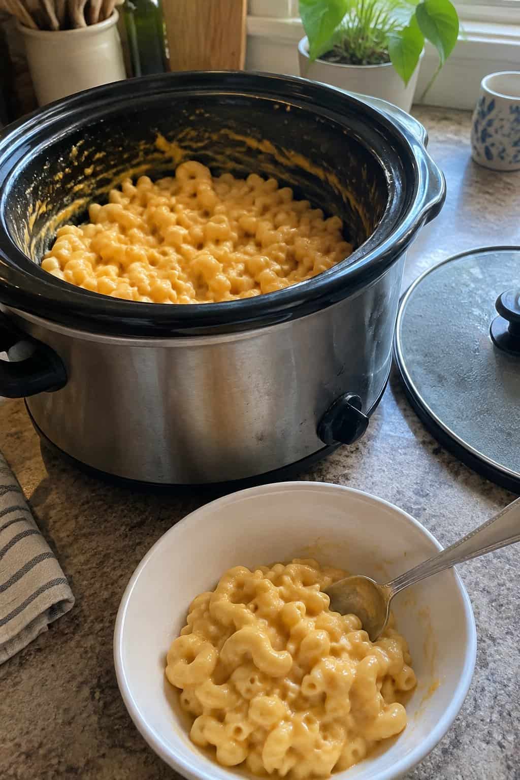Creamy elbow macaroni and cheese with a thick orange cheese sauce clinging to each noodle.