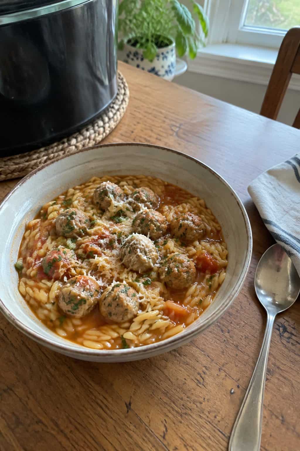 Small orzo pasta mixed with turkey meatballs, herbs, and a light dusting of grated cheese.