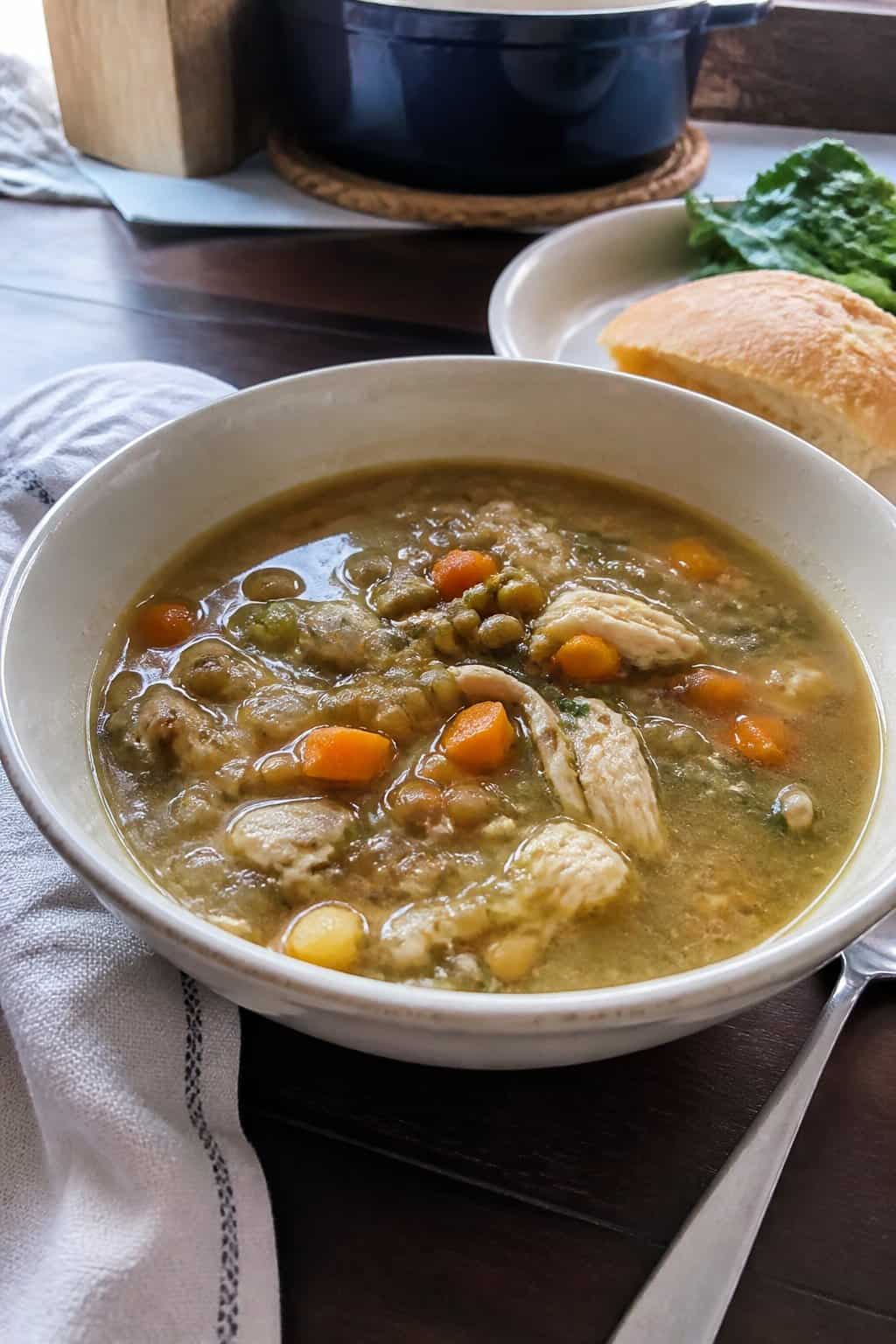 25 Turkey Soup Recipes That Make the Whole House Smell Amazing 16 A bowl of homemade turkey and lentil soup sits on a kitchen table.