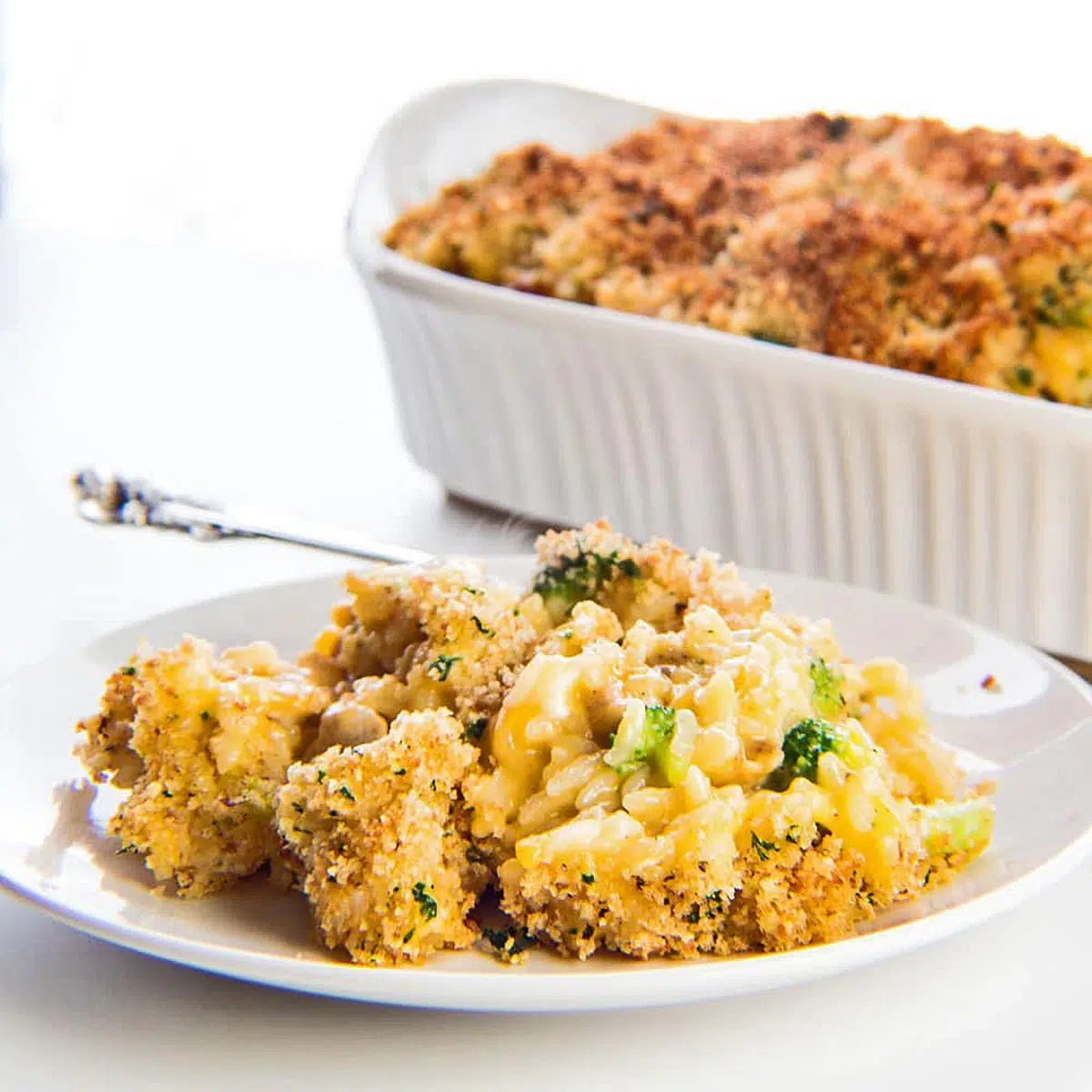 Cheesy chicken, broccoli and rice casserole on a white plate
