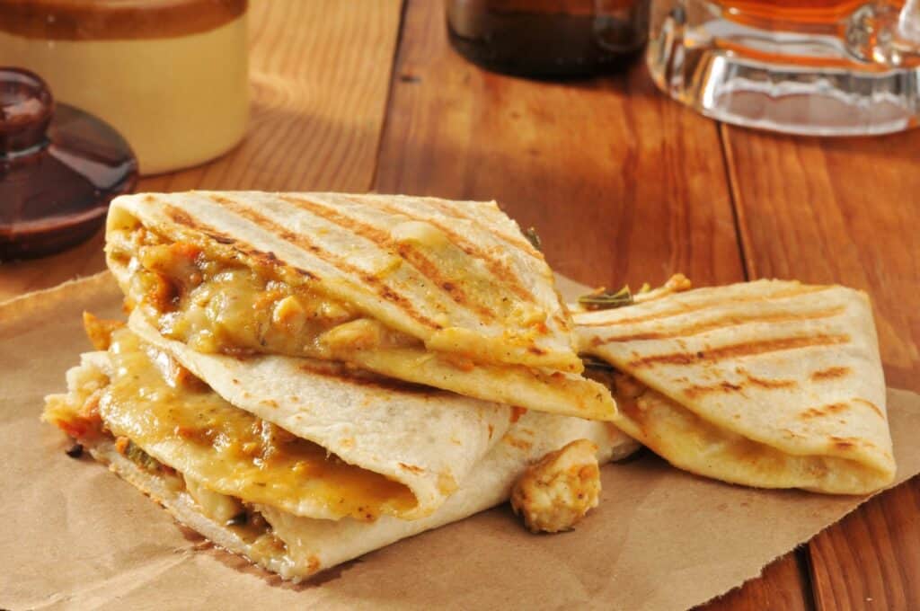 Quick Chicken Dinners for Moms Who Forgot to Thaw Anything 13 Chicken Quesadillas with Shredded Cheese and Salsa on a plate