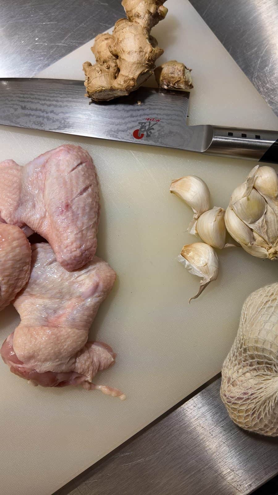 Coca-Cola Chicken Wings for a Sweeter Version of Orange Chicken 2 chicken wing prep after scoring, garlic on side