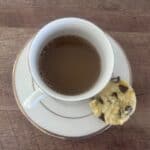 Coconut Corn Muffin with Chocolate Chips next to a small coffee