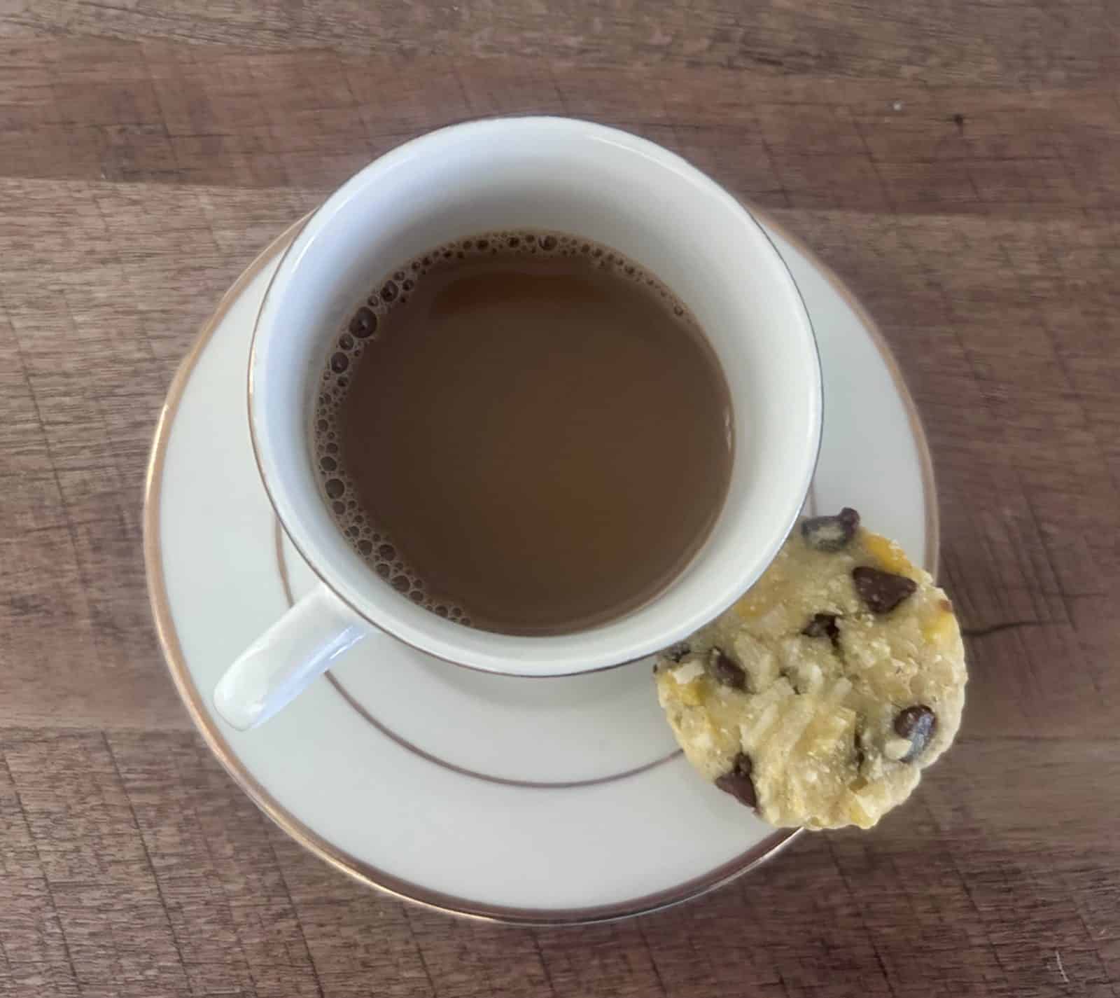 Coconut Corn Muffin with Chocolate Chips next to a small coffee