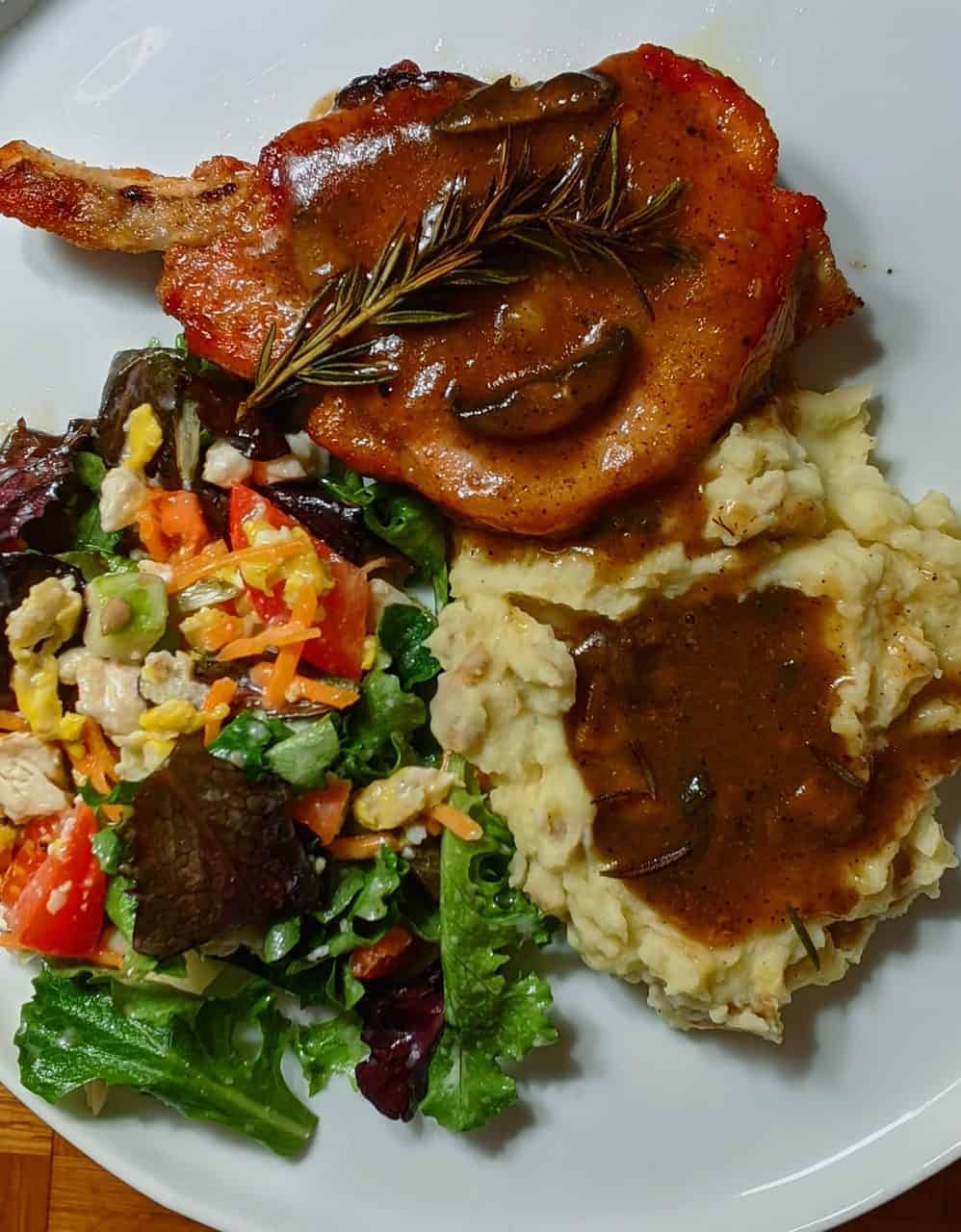 Crockpot Boneless Pork Chop Recipes for Hungry Families 2 Classic Crockpot Pork Chops with Gravy on a plate
