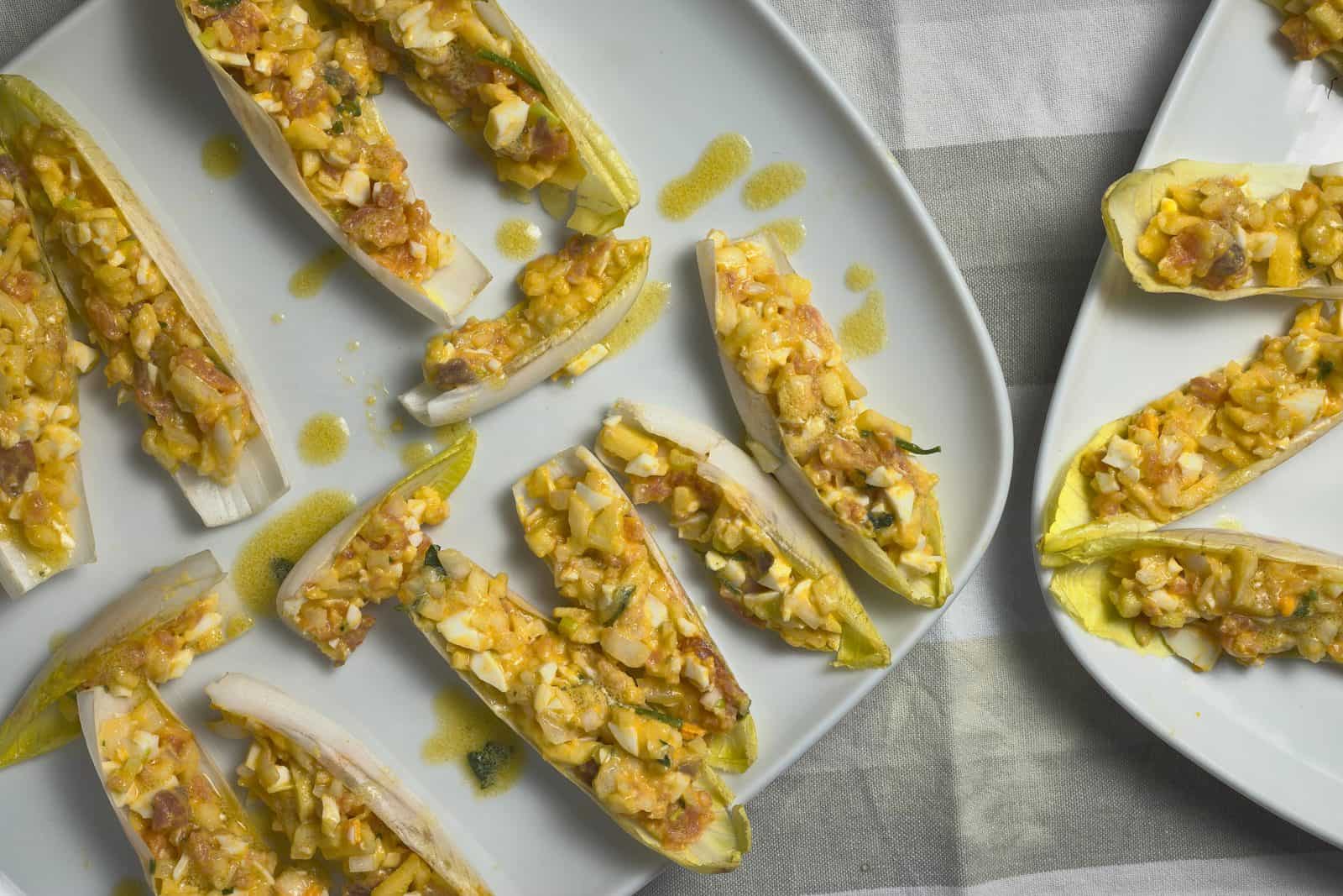 Avocado corn salsa in endive spear