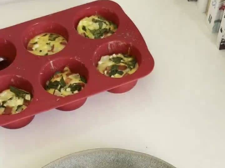Cottage Cheese Veggie Egg Bites with a Potato Crust 7 A round plate holds several baked egg bites with golden potato crusts, ready to eat.
