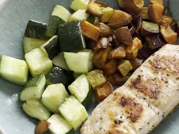 A finished bowl shows a cooked salmon fillet alongside roasted sweet potatoes and diced zucchini.