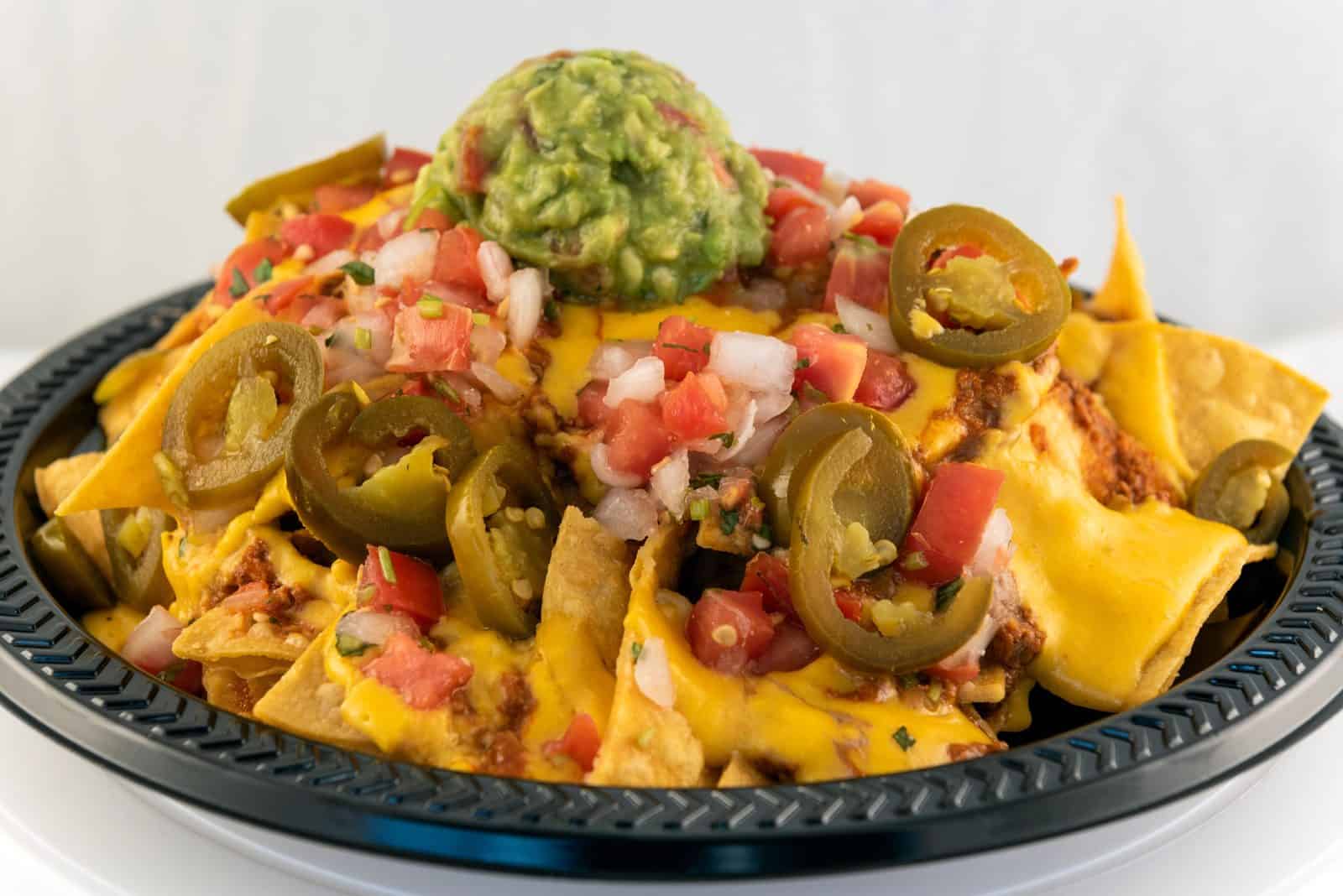 Vegan Appetizers That Disappear Fast at Parties 16 8) Loaded Vegan Nachos on a plate
