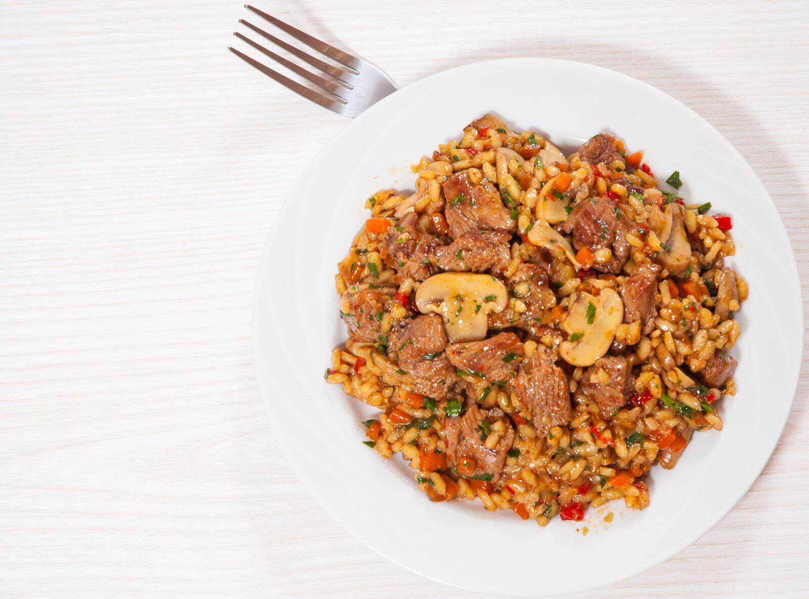 These 20 Easy Ground Beef and Rice Dishes Will Save Your Busy Weeknights 68 Mushroom and Beef Rice Pilaf on a plate