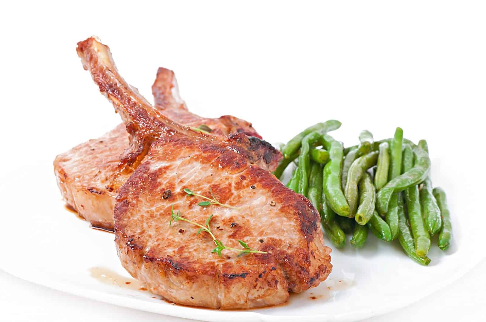 Crockpot Boneless Pork Chop Recipes for Hungry Families 25 Crockpot Pork Chops and Green Beans on a plate