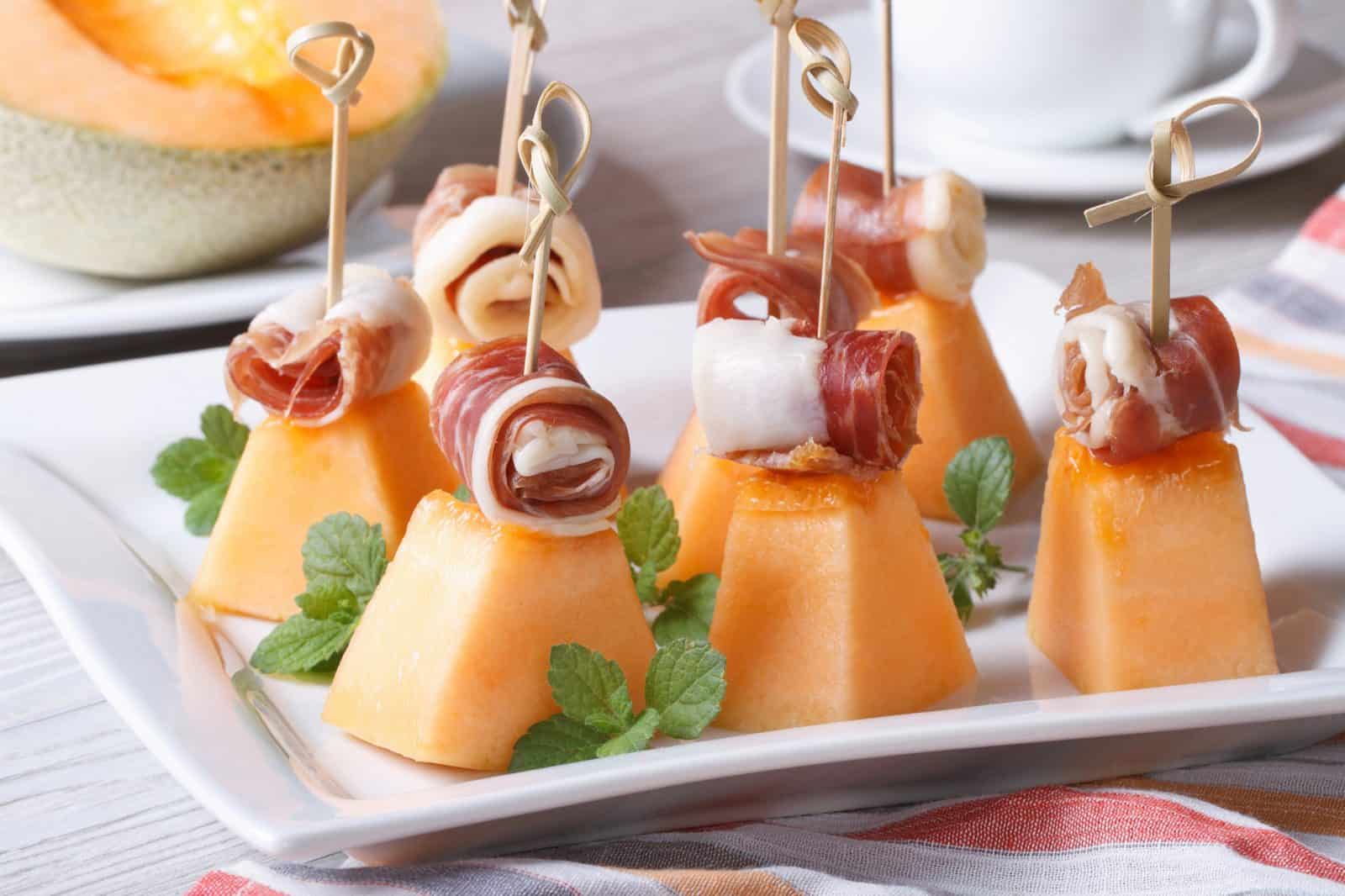 Prosciutto Wrapped Melon Skewers on a plate
