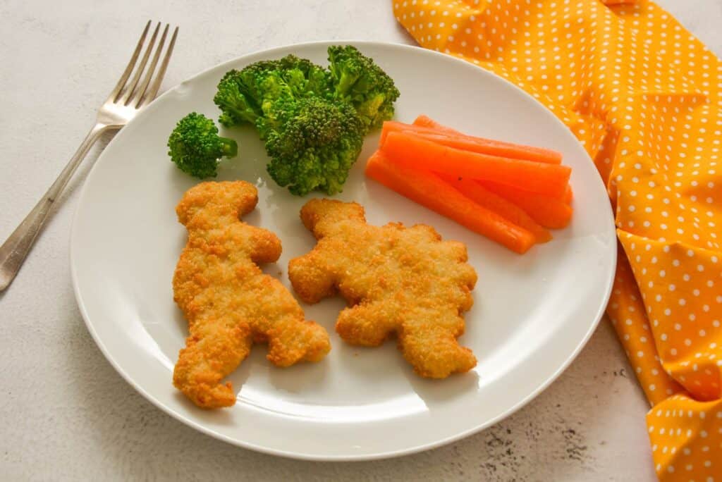 Quick Chicken Dinners for Moms Who Forgot to Thaw Anything 11 Sheet-Pan Chicken Nuggets and Frozen Broccoli on a plate