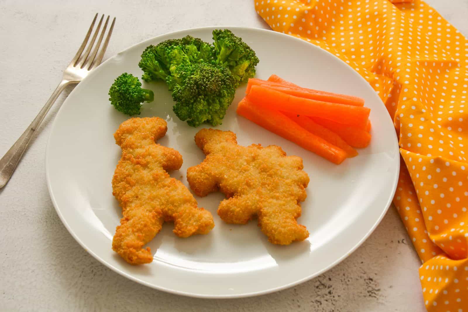 Quick Chicken Dinners for Moms Who Forgot to Thaw Anything 12 Sheet-Pan Chicken Nuggets and Frozen Broccoli on a plate