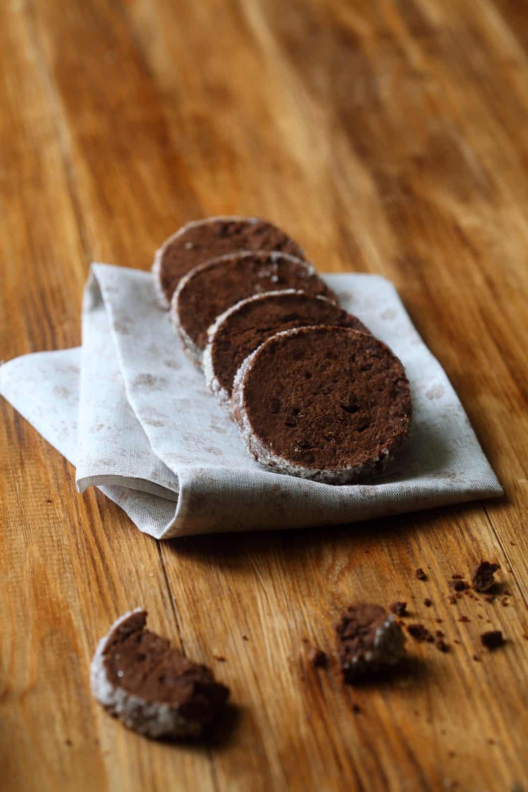 Sliced chocolate shortbread cookies on a linen napkin