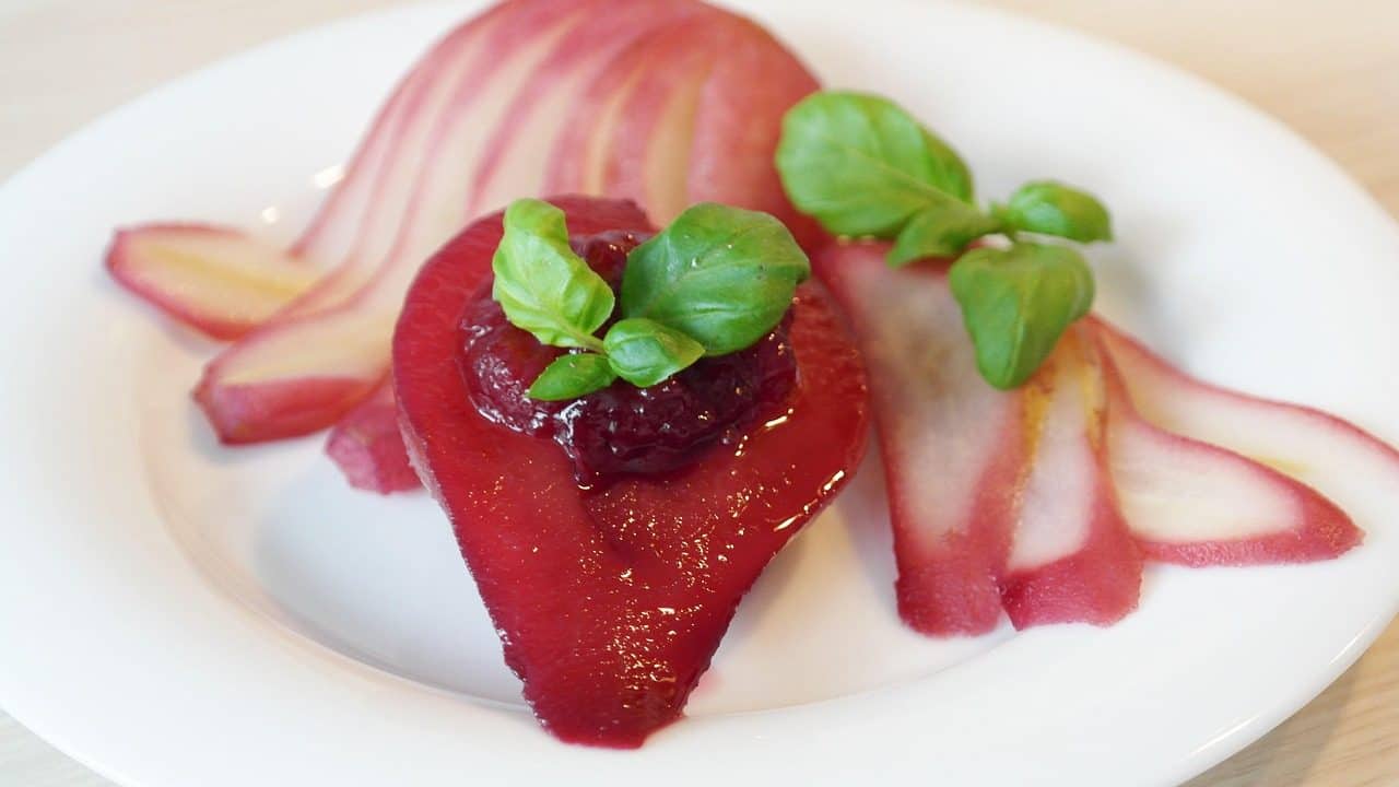 Pear Dessert Recipes for Easy Entertaining 12 Spiced Poached Pears on a plate