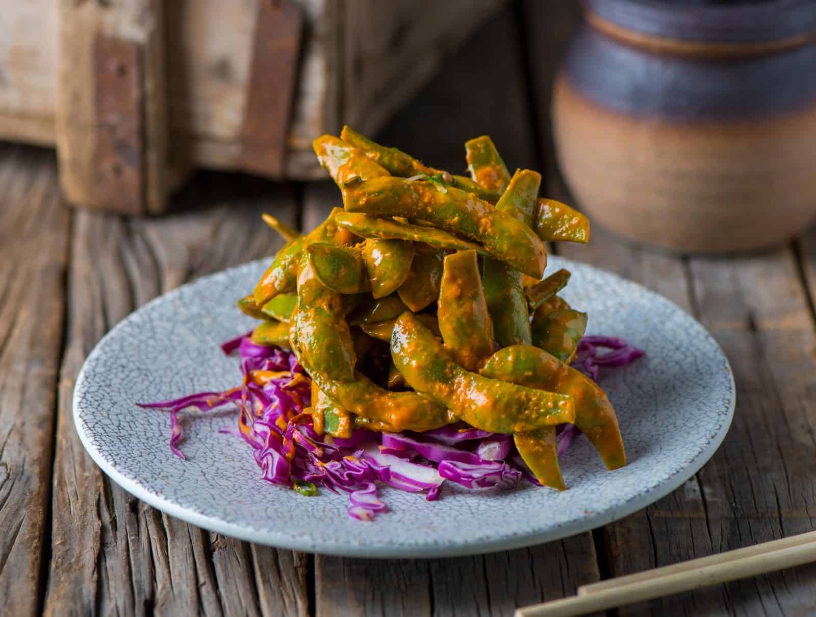Vegan Appetizers That Disappear Fast at Parties 37 Spicy Peanut Edamame on a plate