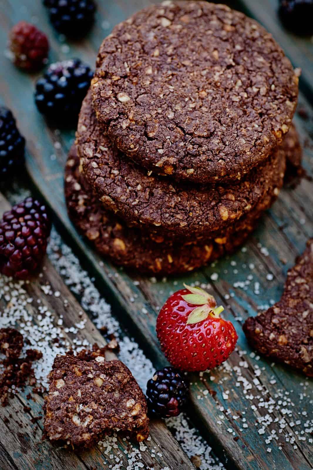 Stacked dark chocolate oatmeal cookies with fresh berries